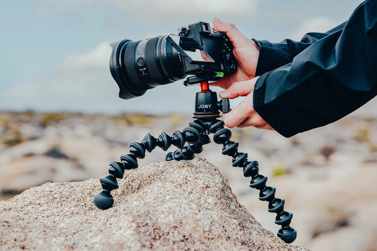 JOBY GorillaPod flexible tripod supporting a camera on uneven rocks during an outdoor shoot.